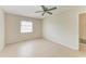 Neutral bedroom with tile floors, ceiling fan, a window, and closet at 2121 Pueblo Cir # V6, Sarasota, FL 34231