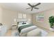 The home-staged primary bedroom features a ceiling fan, neutral paint, and a serene setting at 2121 Pueblo Cir # V6, Sarasota, FL 34231