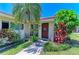 Beautiful condo featuring lush tropical landscaping, healthy green grass, and a welcoming front entrance at 2121 Pueblo Cir # V6, Sarasota, FL 34231