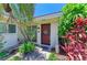 Attractive villa entrance showcasing a well-maintained yard with lush, colorful, tropical landscaping at 2121 Pueblo Cir # V6, Sarasota, FL 34231
