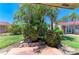 The house features a charming front yard with lush greenery and a stone-paved patio at 2121 Pueblo Cir # V6, Sarasota, FL 34231
