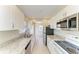 Bright kitchen with white cabinets, granite countertops, stainless steel appliances, and tile flooring at 2121 Pueblo Cir # V6, Sarasota, FL 34231