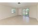 Well-lit living room with tile flooring, a window, and sliding glass doors that bring in plenty of natural light at 2121 Pueblo Cir # V6, Sarasota, FL 34231