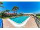 Sparkling community pool with brick trim surrounded by manicured landscaping at 2121 Pueblo Cir # V6, Sarasota, FL 34231