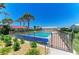 Community pool, surrounded by a secure fence and sun loungers for resident relaxation at 2121 Pueblo Cir # V6, Sarasota, FL 34231