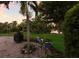 Backyard patio with a grill, planters, and a view of the lush greenery surrounding the property at 2397 Vaccaro Dr, Sarasota, FL 34231
