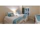 Charming bedroom with two twin beds, decorative pillows, and cozy beach-themed decor at 2397 Vaccaro Dr, Sarasota, FL 34231