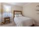 Cozy bedroom features a comfortable queen-sized bed, side table, and natural light from the window at 2397 Vaccaro Dr, Sarasota, FL 34231