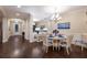 Inviting dining area featuring hardwood floors, a stylish chandelier, and elegant decor at 2397 Vaccaro Dr, Sarasota, FL 34231