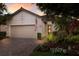 Charming single-Gathering home with a two-car garage, brick driveway, and beautifully landscaped walkway to the front door at 2397 Vaccaro Dr, Sarasota, FL 34231