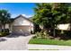 Charming single-story home boasts a well-manicured lawn and a brick driveway with a two-car garage at 2397 Vaccaro Dr, Sarasota, FL 34231