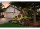 Charming single-Gathering home with a two-car garage and lush landscaping with colorful flowers at 2397 Vaccaro Dr, Sarasota, FL 34231