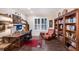 Traditional home office featuring wood desk, bookshelf, chair, and light filtering shutters for comfortable work environment at 2397 Vaccaro Dr, Sarasota, FL 34231