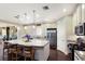 Bright kitchen featuring a large island with barstool seating, stainless steel appliances, and granite countertops at 2397 Vaccaro Dr, Sarasota, FL 34231