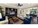 Cozy living room with a decorative wall unit, comfortable seating, and a ceiling fan at 2397 Vaccaro Dr, Sarasota, FL 34231