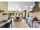 Bright living space with a gas grill, built-in cabinets, and a cozy seating area overlooking the backyard at 2397 Vaccaro Dr, Sarasota, FL 34231