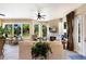 Bright living room with fireplace, large windows offering outdoor views, and comfortable seating arrangement at 2397 Vaccaro Dr, Sarasota, FL 34231