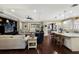 Open-concept living space featuring hardwood floors, a spacious seating area, and a connected kitchen with bar seating at 2397 Vaccaro Dr, Sarasota, FL 34231