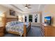 Spacious main bedroom featuring a tray ceiling, wooden furniture, and large windows at 2397 Vaccaro Dr, Sarasota, FL 34231