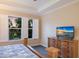 Bright main bedroom with views of the backyard, featuring a spacious layout and comfortable furnishings creating relaxation at 2397 Vaccaro Dr, Sarasota, FL 34231