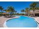 Large community pool surrounded by lots of lounge chairs, and shaded lounge areas for a relaxing day in the sun at 2397 Vaccaro Dr, Sarasota, FL 34231