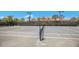 Tennis court with professional surfacing and lighting and shade trees at 2397 Vaccaro Dr, Sarasota, FL 34231