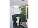 Tiled bathroom featuring a toilet, shower with gold trim, and ample lighting at 2763 Woodgate Ln # 108, Sarasota, FL 34231