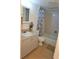Bathroom featuring a shower-tub combo, a toilet, and vanity with sink and blue accent flowers at 2763 Woodgate Ln # 108, Sarasota, FL 34231