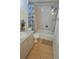 Bathroom featuring a shower-tub combo, a toilet, and vanity with sink and blue accent flowers at 2763 Woodgate Ln # 108, Sarasota, FL 34231