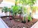 Serene courtyard with mature trees, lush plants and exterior unit access at 2763 Woodgate Ln # 108, Sarasota, FL 34231