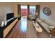 Bright living room with hardwood floors, neutral decor and sliding patio door at 2763 Woodgate Ln # 108, Sarasota, FL 34231
