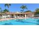 Inviting pool area surrounded by palm trees, lounge chairs, and a safety fence at 2763 Woodgate Ln # 108, Sarasota, FL 34231