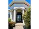 Elegant front entrance showcasing stately columns, a decorative transom window, and beautifully manicured landscaping at 2980 Seasons Blvd, Sarasota, FL 34240
