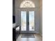 Close-up view of a double-door entry, featuring decorative glass and an arched transom window above at 2980 Seasons Blvd, Sarasota, FL 34240