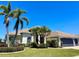 Inviting single-story home featuring lush landscaping, a clay tile roof, and a two-car garage at 2980 Seasons Blvd, Sarasota, FL 34240