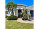 Charming home exterior with lush lawn and landscaping leading up to a welcoming front entrance and two-car garage at 2980 Seasons Blvd, Sarasota, FL 34240