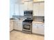 Modern kitchen with stainless steel appliances, white cabinetry, and decorative backsplash at 2980 Seasons Blvd, Sarasota, FL 34240