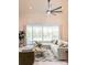Bright, stylish living room with a high ceiling, large windows with a view of the pool, and contemporary decor at 2980 Seasons Blvd, Sarasota, FL 34240