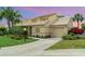 Charming home featuring lush landscaping, a well-manicured lawn, and an attached garage at 3609 57Th Avenue W Dr # 37, Bradenton, FL 34210