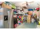 Organized garage with storage shelves, a refrigerator, and ample space for storage at 3609 57Th Avenue W Dr # 37, Bradenton, FL 34210