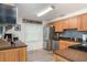 Updated kitchen featuring stainless steel appliances, wood cabinetry, and tile backsplash at 3609 57Th Avenue W Dr # 37, Bradenton, FL 34210