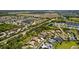 Aerial view of a vibrant community showcases lush greenery and a serene pond, perfect for relaxed living at 3816 Little Country Rd, Parrish, FL 34219