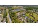 Scenic aerial view of a community featuring verdant green spaces and a peaceful pond at 3816 Little Country Rd, Parrish, FL 34219