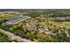 Aerial view of a residential community with mature landscaping, golf course, and peaceful lakes at 3816 Little Country Rd, Parrish, FL 34219