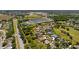 Community aerial showcases lush trees, a tranquil pond, and well-maintained streetscapes at 3816 Little Country Rd, Parrish, FL 34219