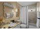 Charming bathroom featuring a unique mirror, granite countertop, and shower-tub combo at 3816 Little Country Rd, Parrish, FL 34219