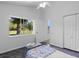 Cozy bedroom with a large window overlooking the lush yard at 3816 Little Country Rd, Parrish, FL 34219