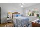 Well-lit bedroom features a bed and a large window overlooking the yard at 3816 Little Country Rd, Parrish, FL 34219