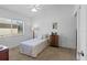 Bright bedroom with a cozy bed, dresser, and ample natural light from a large window at 3816 Little Country Rd, Parrish, FL 34219