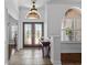 Elegant foyer featuring a double-door entry, decorative transom windows and stone flooring at 3816 Little Country Rd, Parrish, FL 34219
